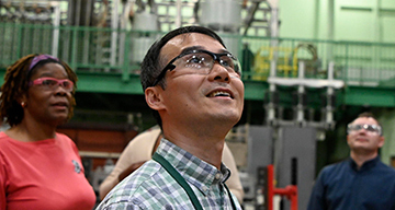 Workers wearing protective glasses looking up and smiling